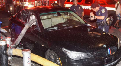 Firefighters Break The Windows Of A BMW Parked In Front Of A Hydrant - Photo